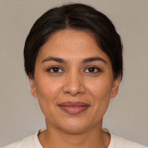 Joyful white adult female with short  brown hair and brown eyes
