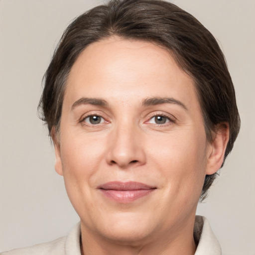 Joyful white adult female with medium  brown hair and brown eyes