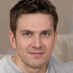 Joyful white adult male with short  brown hair and brown eyes