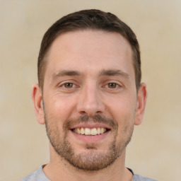 Joyful white young-adult male with short  brown hair and brown eyes