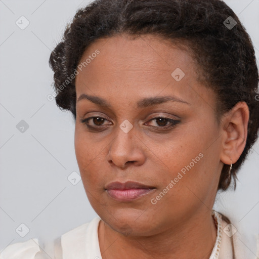 Joyful black young-adult female with short  brown hair and brown eyes