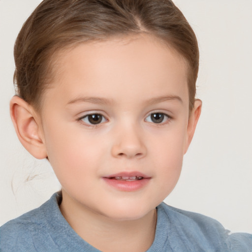 Joyful white child female with short  brown hair and brown eyes