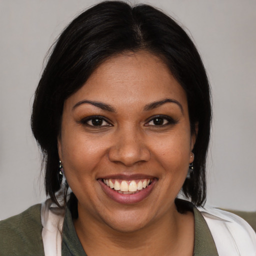 Joyful latino young-adult female with medium  brown hair and brown eyes