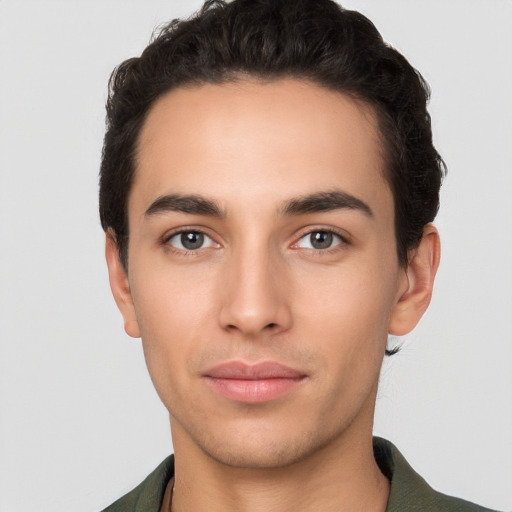 Joyful white young-adult male with short  black hair and brown eyes