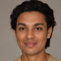 Joyful latino young-adult male with short  brown hair and brown eyes