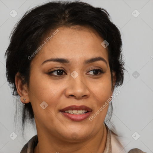 Joyful latino adult female with medium  brown hair and brown eyes