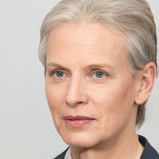 Neutral white middle-aged female with medium  gray hair and grey eyes