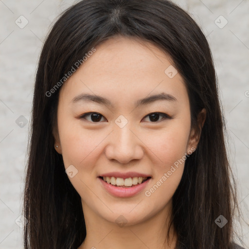 Joyful asian young-adult female with long  brown hair and brown eyes