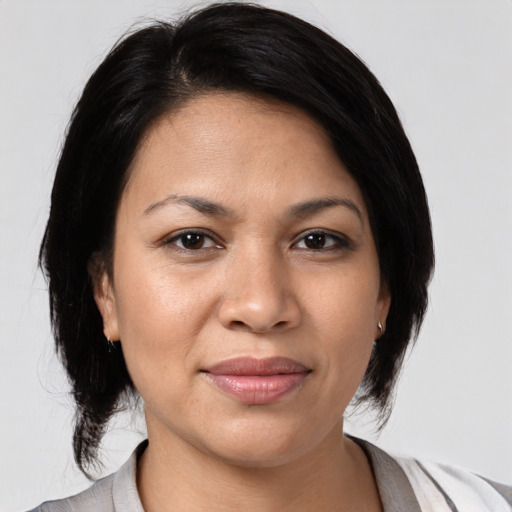 Joyful latino young-adult female with medium  black hair and brown eyes