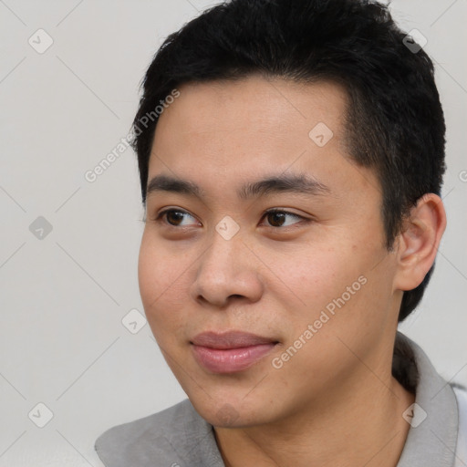 Joyful asian young-adult male with short  black hair and brown eyes