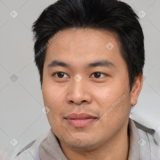 Joyful asian young-adult male with short  brown hair and brown eyes