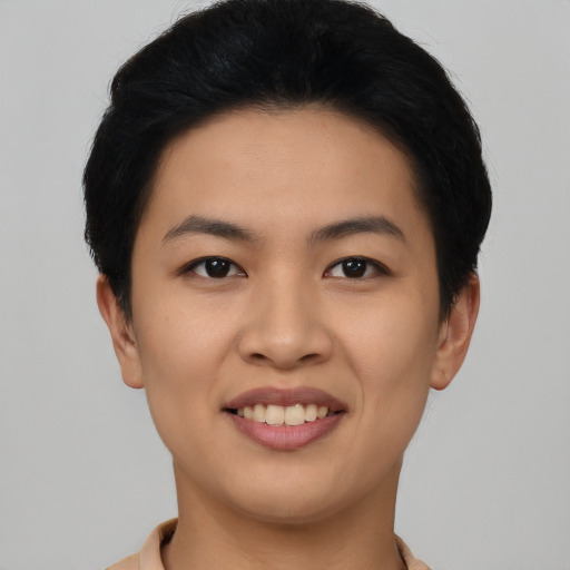 Joyful asian young-adult female with short  black hair and brown eyes
