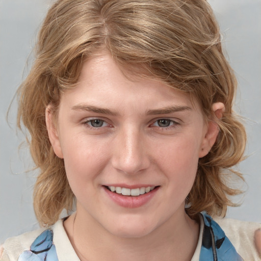 Joyful white young-adult female with medium  brown hair and blue eyes