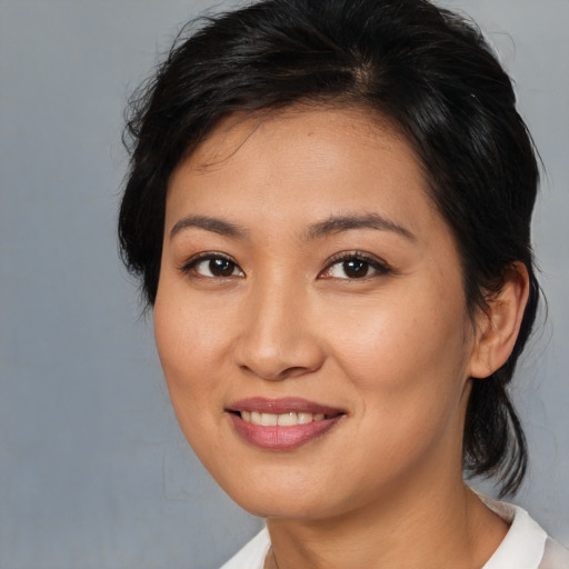 Joyful asian young-adult female with medium  brown hair and brown eyes