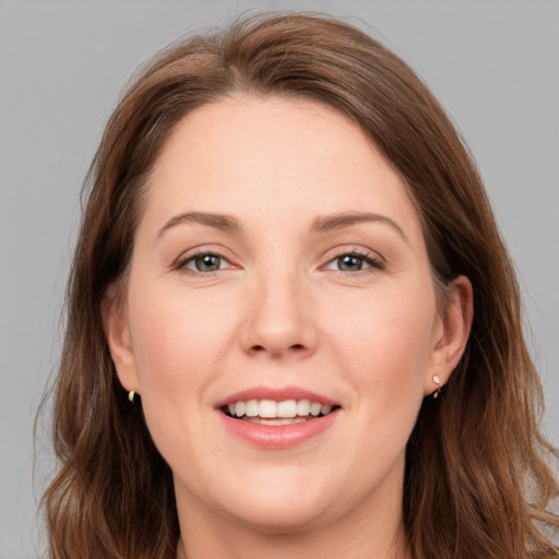 Joyful white young-adult female with long  brown hair and grey eyes