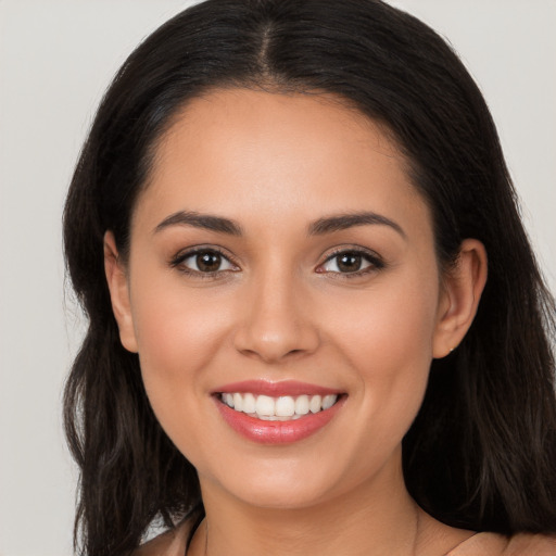 Joyful white young-adult female with long  brown hair and brown eyes