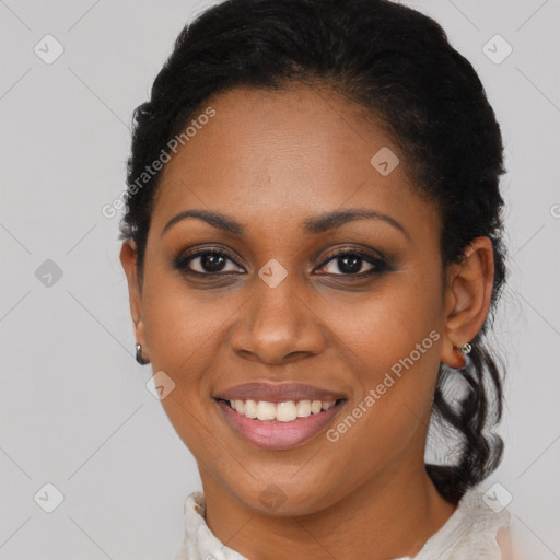 Joyful black young-adult female with short  black hair and brown eyes