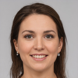 Joyful white young-adult female with medium  brown hair and grey eyes