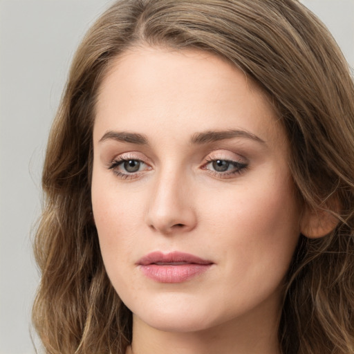 Joyful white young-adult female with long  brown hair and green eyes