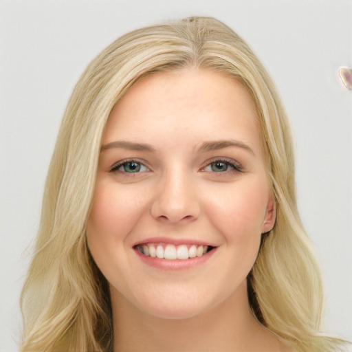 Joyful white young-adult female with long  brown hair and blue eyes