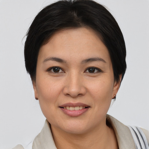 Joyful asian young-adult female with short  brown hair and brown eyes