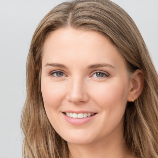 Joyful white young-adult female with long  brown hair and grey eyes