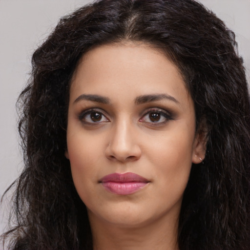 Joyful latino young-adult female with long  brown hair and brown eyes
