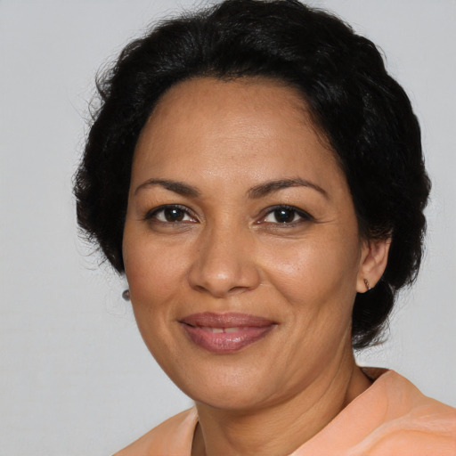 Joyful latino adult female with medium  brown hair and brown eyes