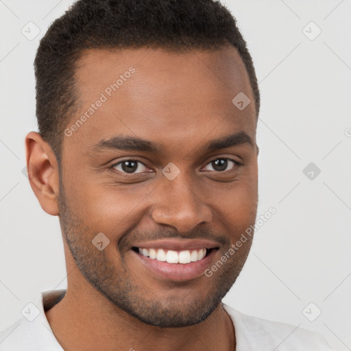 Joyful black young-adult male with short  brown hair and brown eyes