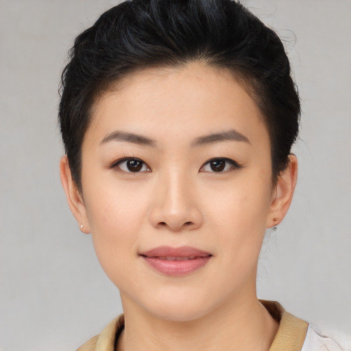 Joyful asian young-adult female with short  black hair and brown eyes