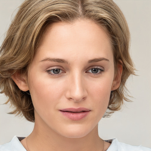 Joyful white young-adult female with medium  brown hair and blue eyes