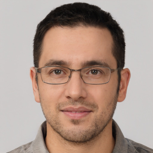 Joyful white adult male with short  brown hair and brown eyes