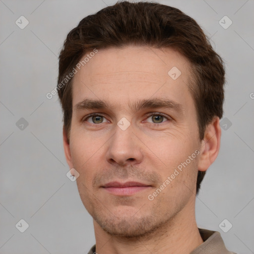 Joyful white adult male with short  brown hair and grey eyes