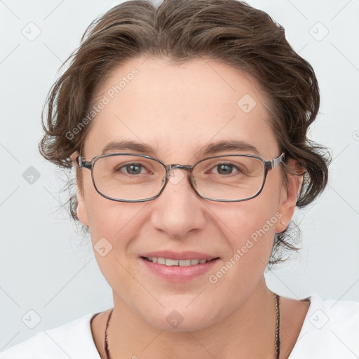 Joyful white adult female with medium  brown hair and blue eyes