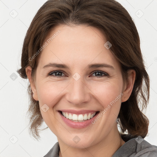 Joyful white young-adult female with medium  brown hair and grey eyes