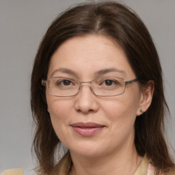 Joyful white adult female with medium  brown hair and brown eyes