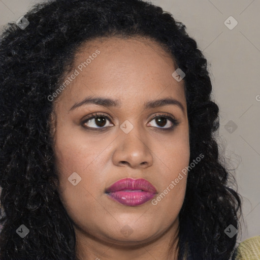 Joyful black young-adult female with long  brown hair and brown eyes