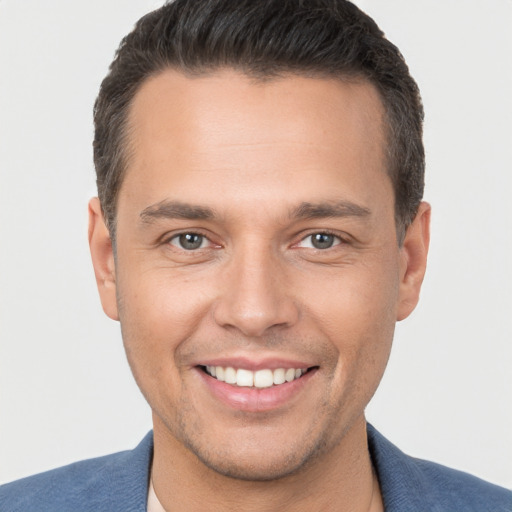 Joyful white young-adult male with short  brown hair and brown eyes