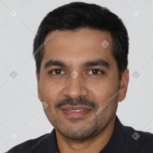 Joyful latino young-adult male with short  black hair and brown eyes