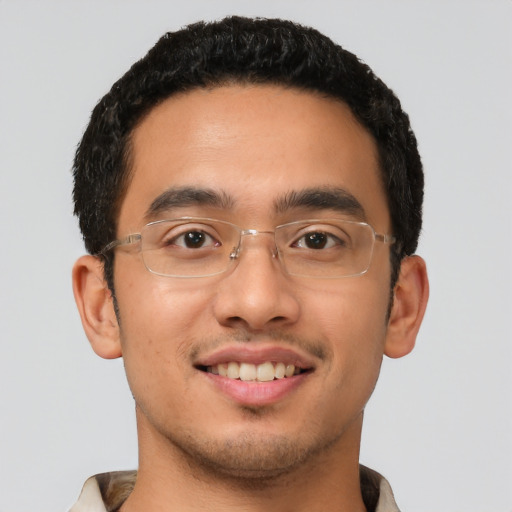Joyful latino young-adult male with short  brown hair and brown eyes