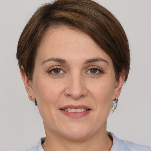 Joyful white adult female with short  brown hair and brown eyes