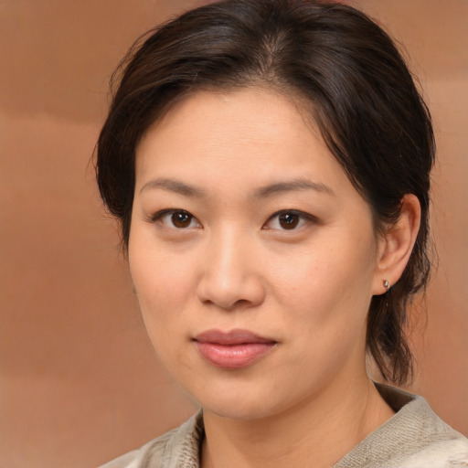 Joyful asian young-adult female with medium  brown hair and brown eyes