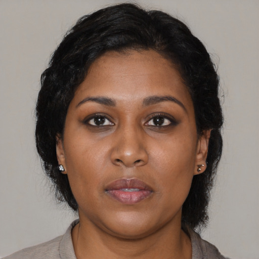 Neutral black young-adult female with long  brown hair and brown eyes