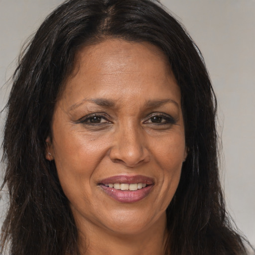 Joyful white adult female with long  brown hair and brown eyes