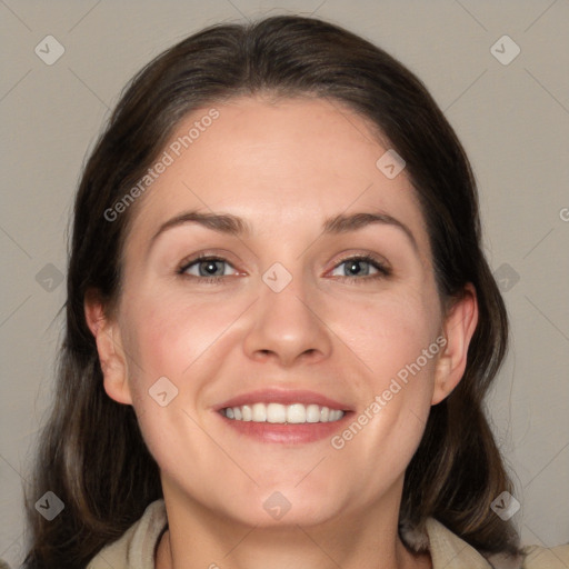 Joyful white adult female with medium  brown hair and brown eyes