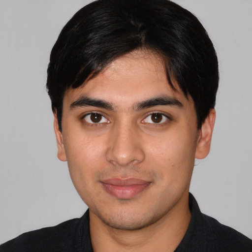 Joyful white young-adult male with short  black hair and brown eyes