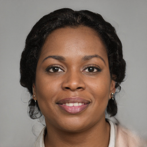 Joyful black young-adult female with medium  black hair and brown eyes