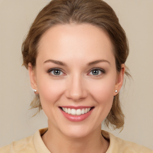 Joyful white young-adult female with medium  brown hair and brown eyes