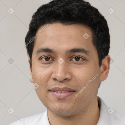 Joyful latino young-adult male with short  black hair and brown eyes