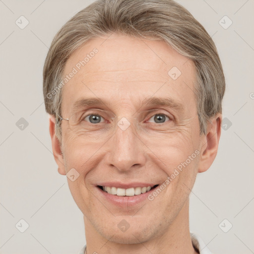 Joyful white adult male with short  brown hair and grey eyes